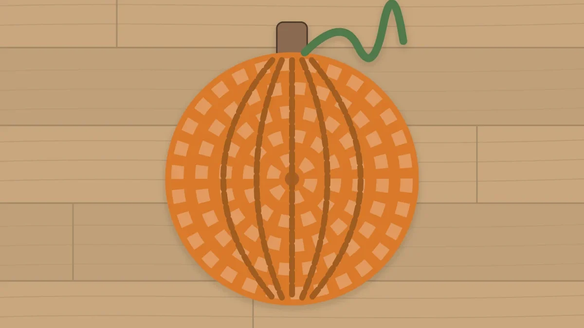 An orange pumpkin-shaped round coaster with a short brown stem and a green curl